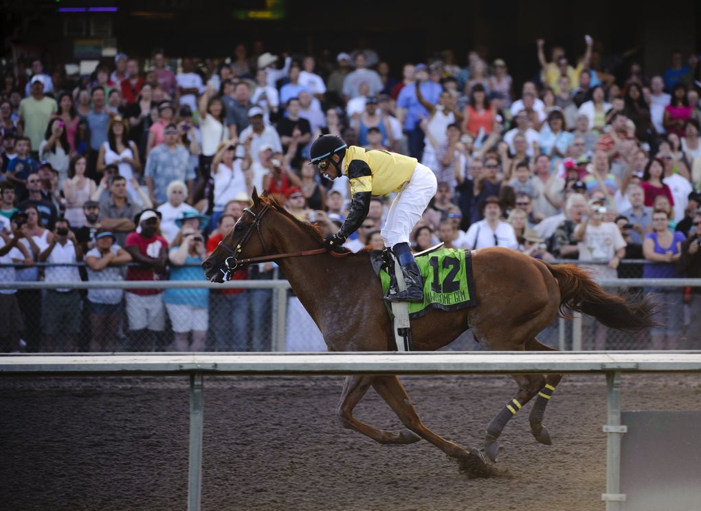 Awesome Gem, ridden by David Flores, passes the finish line to win the Longacres Mile on Aug. 21, 2011, at Emerald Downs. (Joel Hawksley / The Seattle Times)