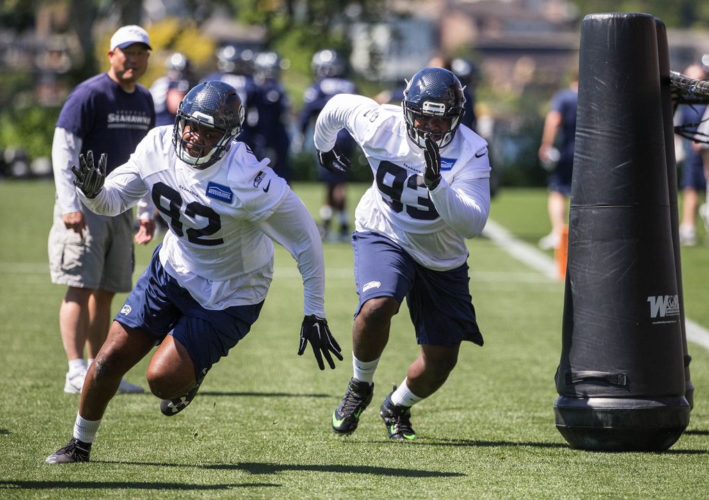 Defensive tackles Quinton Jefferson, left, and Jarran Reed run through drills Friday at Seahawks rookie minicamp. (Dean Rutz / The Seattle Times)