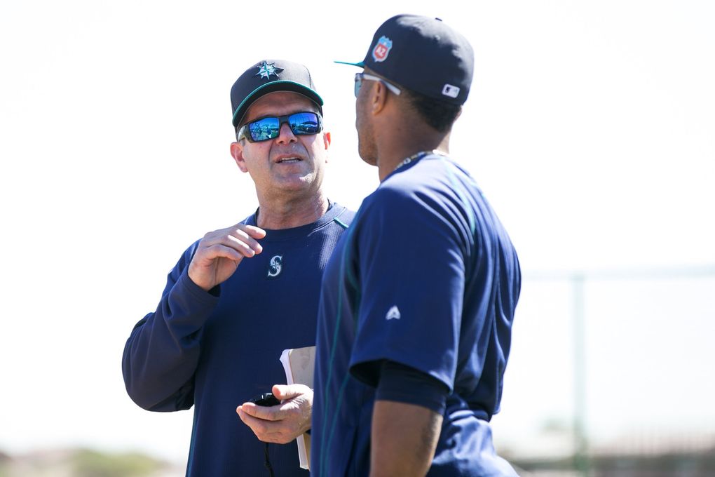 Mariners hitting coach Edgar Martinez talks with Robinson Cano at spring training Feb. 25 in Peoria, Ariz. (Bettina Hansen / The Seattle Times)