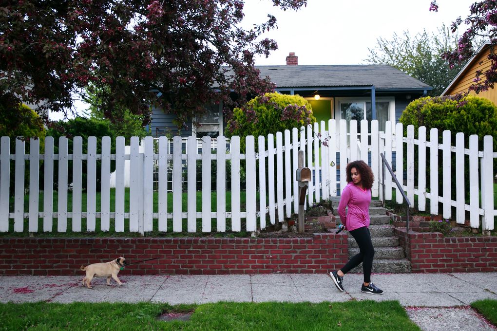 Jessica O’Brien, 36, walks her pug in the Central District. She grew up in the CD but when she moved back, she felt that neighbors weren’t friendly. (Erika Schultz/The Seattle Times)