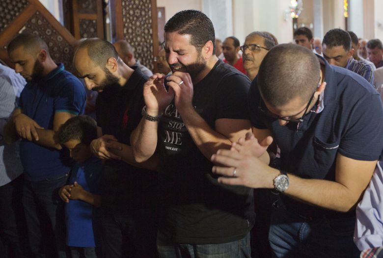 Egyptian film director Osman Abu Laban, center, who lost four relatives, all victims of Thursday’s EgyptAir plane crash, attends prayers for the dead, at al Thawrah Mosque, in Cairo, Egypt, Friday, May 20, 2016. The Airbus A320 plane was flying from Paris to Cairo with 66 passengers and crew when it disappeared early Thursday over the Mediterranean Sea. (AP Photo/Amr Nabil)