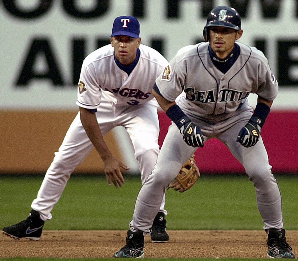 Seattle Mariners’ Ichiro Suzuki, front, and Texas Rangers shortstop Alex Rodriguez (3) stand ready during the first inning in Arlington, Texas, Friday, April 6, 2001. Suzuki reached base on a lead-off double and scored on a two-run homer by Mark McLemore. (AP Photo/LM Otero)