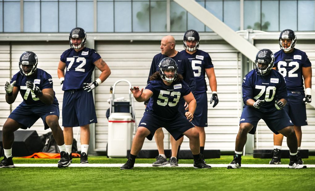 From left, Germain Ifedi, (76) Joey Hunt, (53) and Rees Odhiambo, (70) run drills with the offensive line at the Seahawks’ rookie minicamp at the Virginia Mason Athletic Center on Sunday. (Bettina Hansen/The Seattle Times)