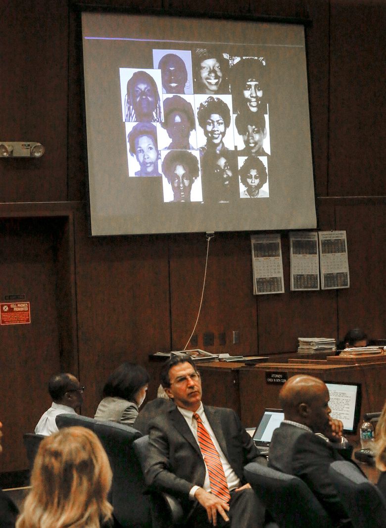 FILE – In this May 2, 2016 file photo, a montage of photos of alleged victims is projected on a screen in the courtroom during the during closing arguments in the serial murder trial of Lonnie Franklin Jr., seated at far left, in Los Angeles Superior Court. Franklin was convicted Thursday, May 5, 2016, of 10 murders and one attempted murder in the serial killings that were dubbed the work of the “Grim Sleeper” because of a 14-year gap in slayings that spanned two decades in South Los Angeles and targeted vulnerable young black women in the inner city. (Mark Boster/ Los Angeles Times, Pool, File)