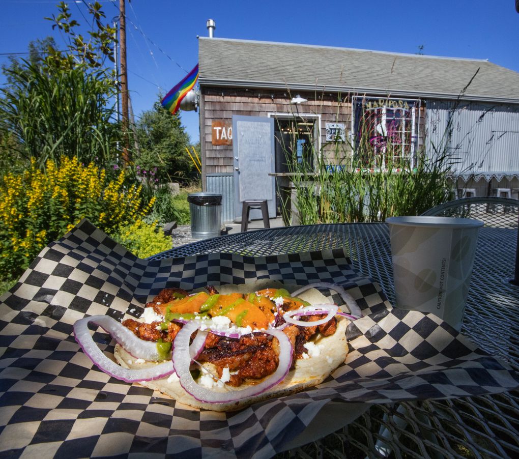 One of the larger-than-average tacos is ready to eat at an outside table at Mariposa Taqueria in Edison. (Steve Ringman/The Seattle Times)