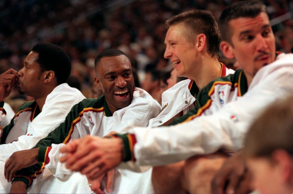 From left, Sam Perkins, Hersey Hawkins, Detlef Schrempf and Frank Brickowski sit on the bench during a 1996 postseason game. (Dean Rutz / The Seattle Times)