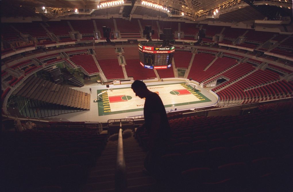 A worker dusts in the upper level of the renovated KeyArena in 1995. (Mike Siegel / The Seattle Times)