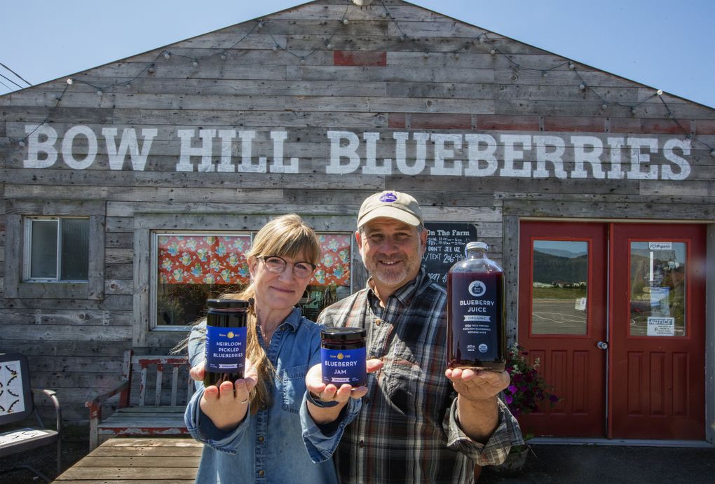 Susan and Harley Soltes, owners of Bow Hill Blueberries, with products they make in the offseason, including pickled blueberries, blueberry jam and juice. The new crop should be ready to pick by mid-July. (Steve Ringman/The Seattle Times)