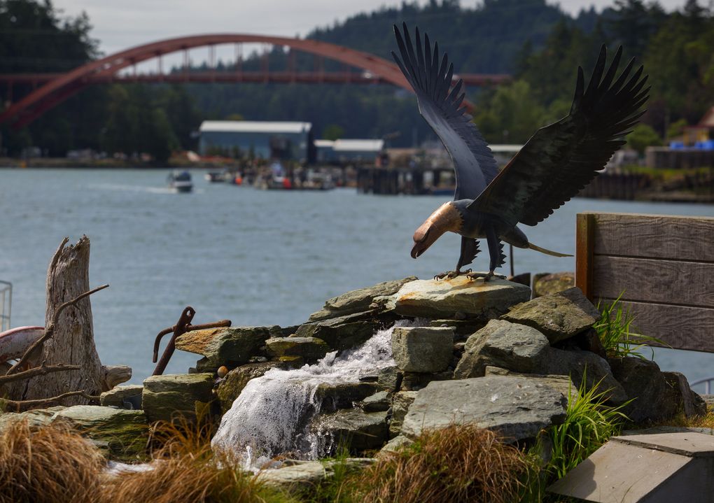 A sculpture of an eagle “lands” on a water feature edging the Swinomish Channel in La Conner. A new waterfront boardwalk gives up-close views of the channel and its Rainbow Bridge. (Ellen M. Banner/The Seattle Times)