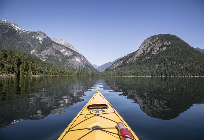 Kayaking on Ross Lake at the North Cascades National Park, where you can hear live classical music this summer. (Steve Ringman / The Seattle Times)