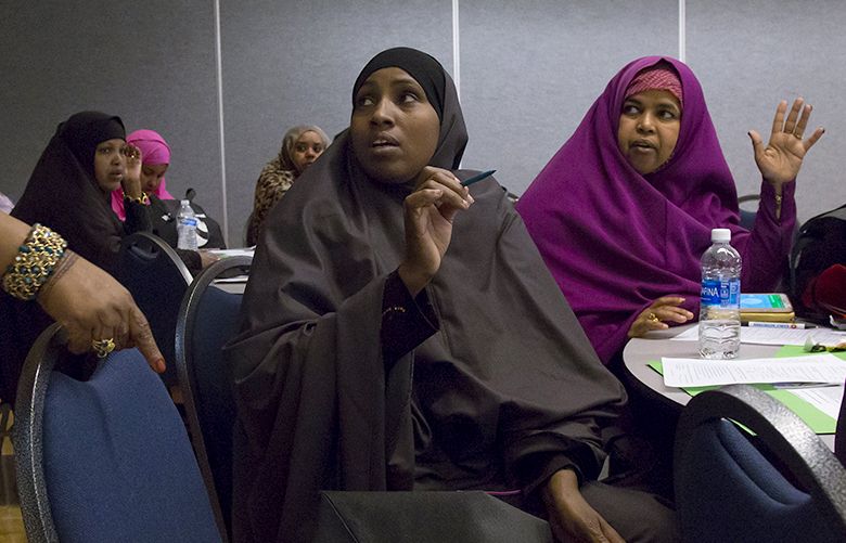 Halina Maalim, a local childcare provider, chats with other care providers in one of the breakout groups during  the Voices of Tomorrow’s second annual conference at the Tukwila Community Center, Saturday, May 28, 2016.
