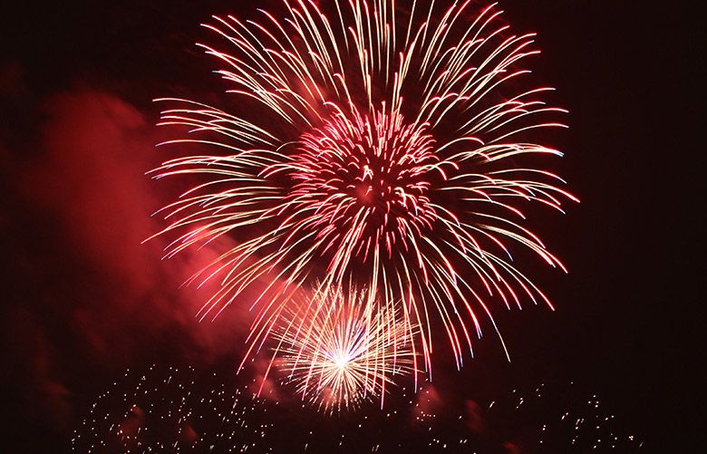 Fireworks explode over Lake Union near Gas Works Park as a part of the Seafair Summer Fourth celebration. (Sophia Nahli Allison / The Seattle Times)