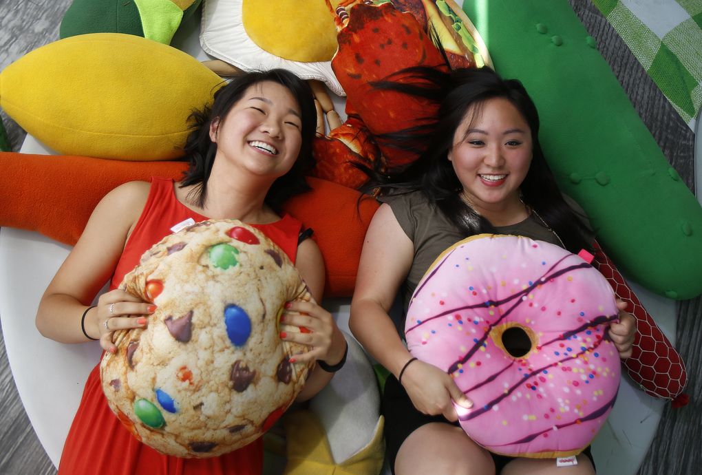 It’s OK to play with some of your food at the Bite of Seattle. Jane Park, left, and Paulette King have fun with a plate of fake food at last year’s three-day food fest at Seattle Center. (Sy Bean / The Seattle Times)
