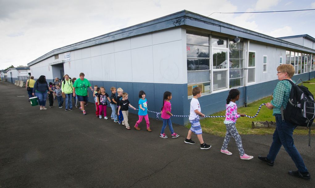 Michelle Weiberg leads her preschool students during an earthquake drill at Hopkins Preschool Center in Aberdeen. (Ellen M. Banner/The Seattle Times)