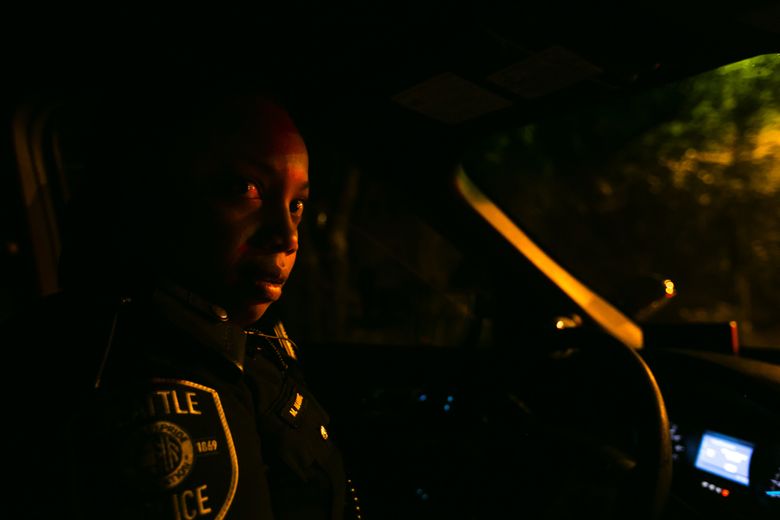 Between calls, officer Melisande Manning patrols the streets on Capitol Hill. She scans license plates of cars that might be stolen and keeps an eye out for anything amiss. (Bettina Hansen/The Seattle Times)