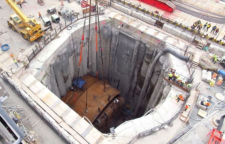 The view over a 120-foot deep access pit Thursday, March 19, 2015, as cranes begin to lift a 270-ton section of the front shield of “Bertha,” the massive tunnel boring machine currently stopped underground for repairs near downtown Seattle. The machine was digging a 1.7-mile highway tunnel as a replacement for the Alaskan Way Viaduct.