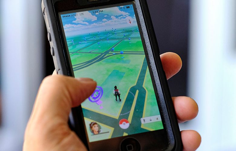 Pokemon Go is displayed on a cell phone. Just days after being made available in the U.S., the mobile game Pokemon Go has jumped to become the top-grossing app in the App Store. And players have reported wiping out in a variety of ways as they wander the real world, eyes glued to their smartphone screens, in search of digital monsters. (AP Photo / Richard Vogel)