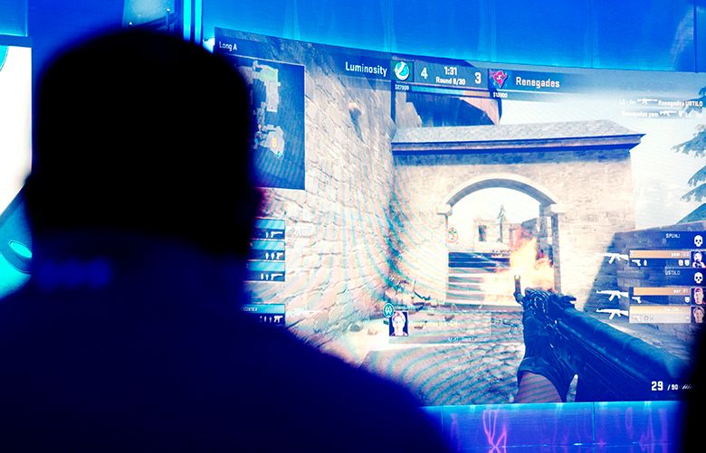Spectators watch a gaming competition in the ELEAGUE arena at Turner Studios, Tuesday, May 24, 2016, in Atlanta. Video gaming makes another attempt to go mainstream, this time with the ELEAGUE, a joint venture between Turner Sports and IMG that kicks off in a high-tech studio near downtown Atlanta. Twenty-four teams are playing Counter-Strike: Global Offensive for $1.4 million in prize money, but the stakes are much higher for those who think a bunch of headset-wearing guys sitting at computer consoles can someday be viewed as a legitimate sport. (AP Photo/David Goldman)