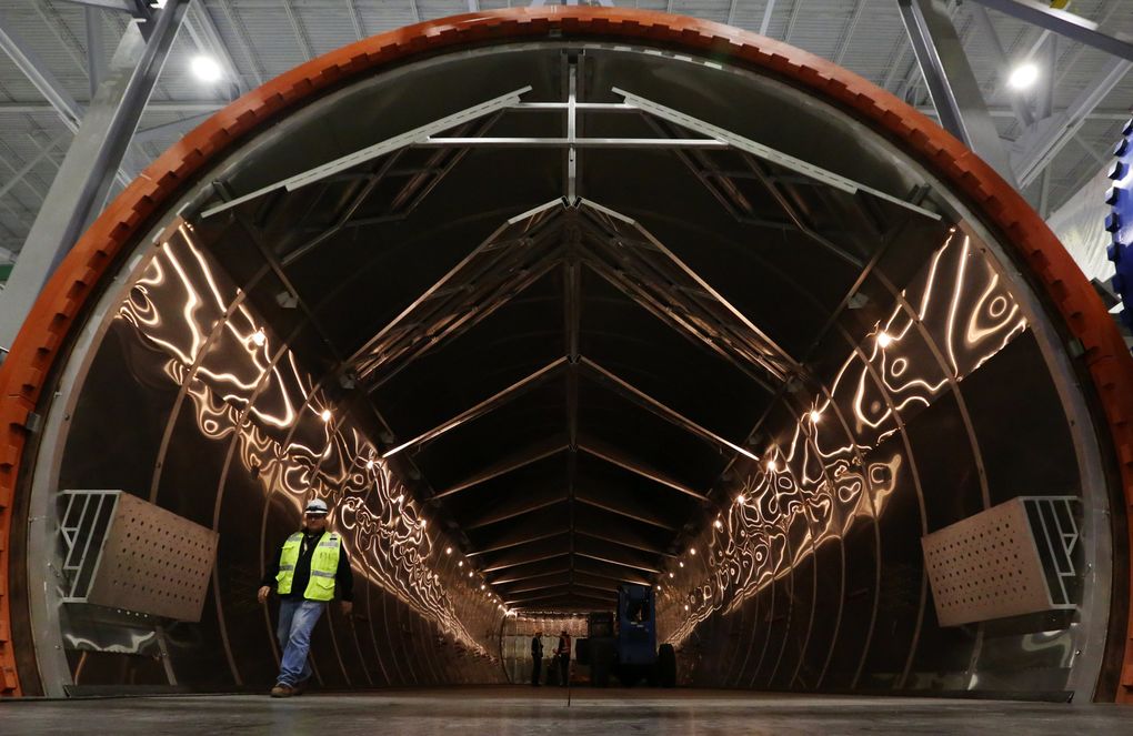 A worker emerges from the autoclave, where parts will be “baked” at Boeing’s massive new 777X composite wing center. (Ken Lambert / The Seattle Times)