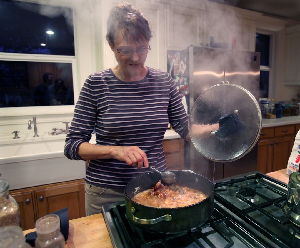 Melany Vorass in her kitchen cooking the squirrel in a risotto with broth, onions, white wine and mushrooms. She traps and eats squirrels as part of her sustainable-living philosophy. (Steve Ringman / The Seattle Times)