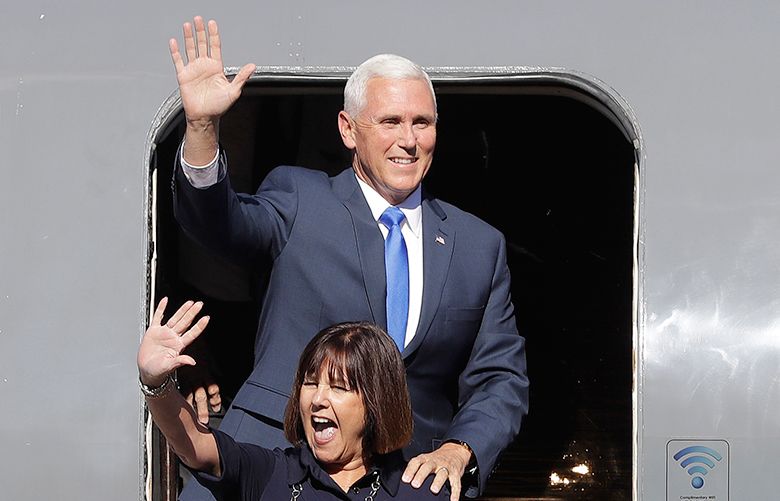 Indiana Gov. Mike Pence waves with his wife, Karen, and daughter, Charlotte, as they arrive for a Welcome Home Rally, Saturday, July 16, 2016, in Zionsville, Ind. Republican presidential candidate Donald Trump announced Pence as his vice presidential running mate. (AP Photo/Darron Cummings)