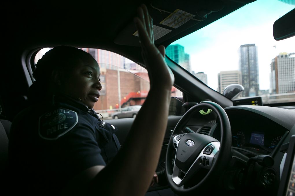 Officer Melisande Manning waves to a passer-by on the street while on patrol on Capitol Hill. (Bettina Hansen/The Seattle Times)