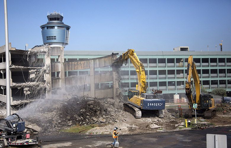 Crews demolish a parking garage at La Guardia Airport in New York, Aug. 26, 2016. The teardown is one of the first steps in an eight-year, $8-billion plan to turn La Guardia into a first-class travel hub, but for the time being, the already-difficult ordeal of getting to and from New York Cityâ€™s second airport has suddenly become even worse. (Uli Seit/The New York Times)
