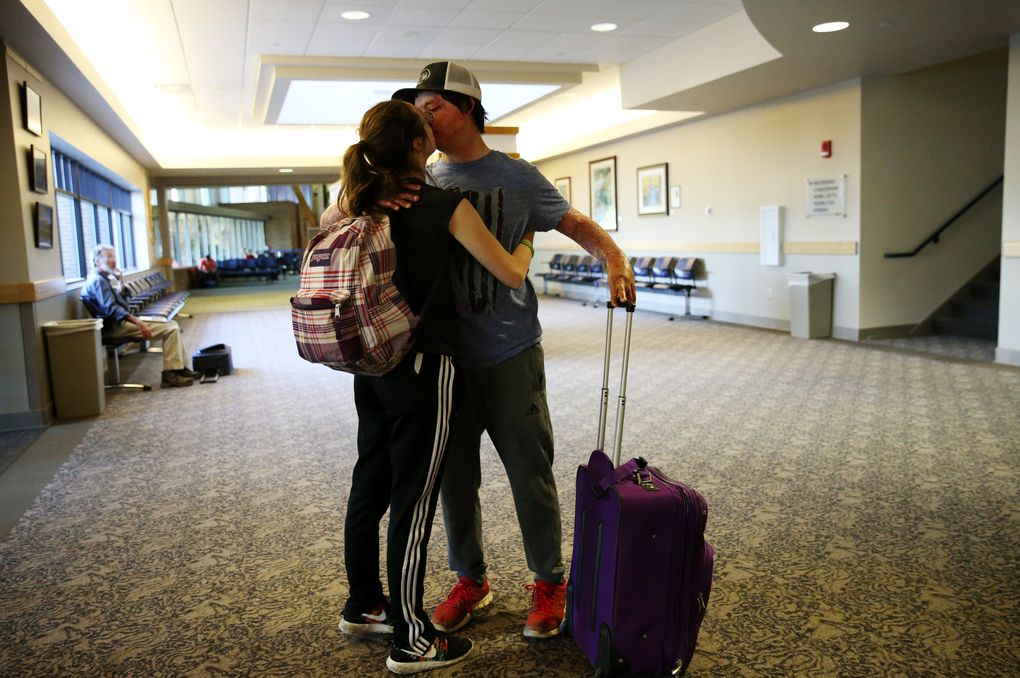 Daniel Lyon Jr. kisses girlfriend Megan Lanfear, 19, of Seattle, as she leaves the Missoula airport. (Ken Lambert/The Seattle Times)