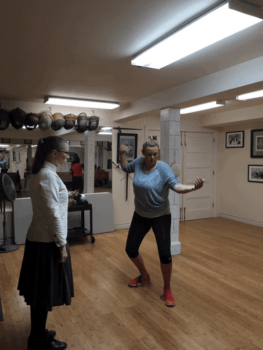 Kristen Gowdy practices fencing footwork at Salle St. George in Seattle on July 19. Good footwork is very important in fencing. (Nick Sullivan / The Seattle Times)