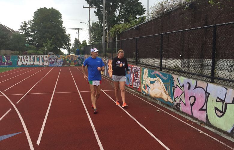 Kristen Gowdy learns to race walk from Steve DiBernardo at Garfield High School on August 2nd. (Stefanie Loh / The Seattle Times)