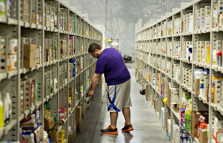 An employee grabs an item from a shelf at the Jet.com Inc. fulfillment center on Cyber Monday in Kansas City, Kansas, U.S., on Monday, Nov. 30, 2015. Online sales on Cyber Monday may rise at least 18 percent from a year earlier, slower growth than during the holiday weekend, as consumers start their Internet shopping earlier, according to forecasts by International Business Machines Corp. Photographer: Daniel Acker/Bloomberg