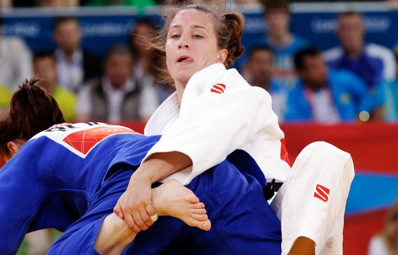 Marti Malloy of the United States, right, and Corina Caprioriu of Romania during the women’s 57-kg judo competition at the 2012 Summer Olympics, Monday, July 30, 2012, in London. (AP Photo/Paul Sancya)    OJUD184