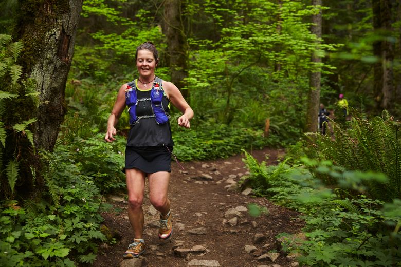 Record-setting hiker Heather Anderson runs the Chirico Trail on Tiger Mountain. Anderson completed 10 laps up and down for a total elevation gain of 16,600 feet, starting at 7 a.m. and finishing around 5 p.m.  (Benjamin Benschneider/The Seattle Times)