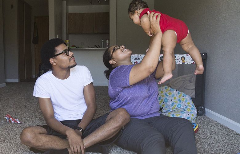 Murray Duncan and Alyssa Dunn were living with their son, now 8-months-old, Noel Acosta-Duncan, in their car several months ago before Stephanie Bjorkman, a state trooper, helped them. Now they are living in a new apartment raising their son. (Sophia Nahli Allison / The Seattle Times)