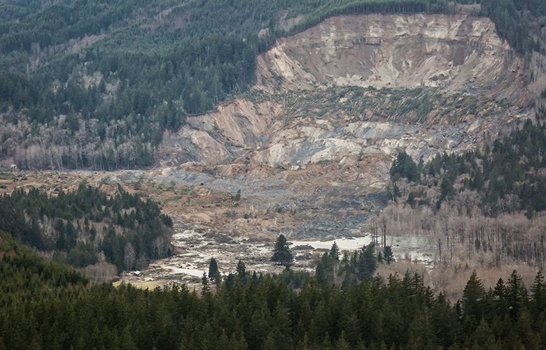 An aerial view shows a huge volume of earth missing from the side of a hill facing Stillaguamish River, in a landslide along State Route 530, between the cities of Arlington and Darrington, on Saturday, March 22, 2014. Search and rescue operations are underway for survivors. 

(Photograph by MARCUS YAM/The Seattle Times)
Assignment ID: 137375
Methode ID: 3.0.2391268191#News#Local#20140323#3.0.2391344857