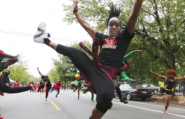 Athletic and spirited, La-Twon Allen CQ and other members of the All City Dance team head east on Cherry Street in the Umoja Fest 2016 parade on Sat. Aug 6, 2016.