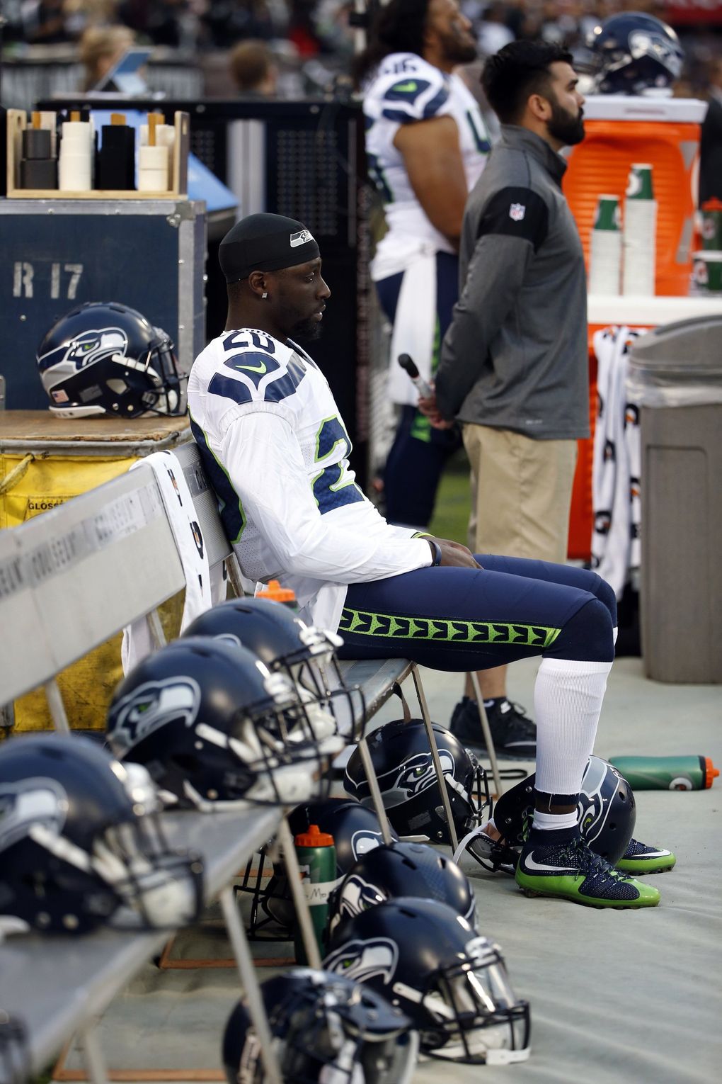 Seahawks cornerback Jeremy Lane sits as the national anthem plays before a preseason game against the Raiders on Thursday in Oakland. (Tony Avelar / AP)
