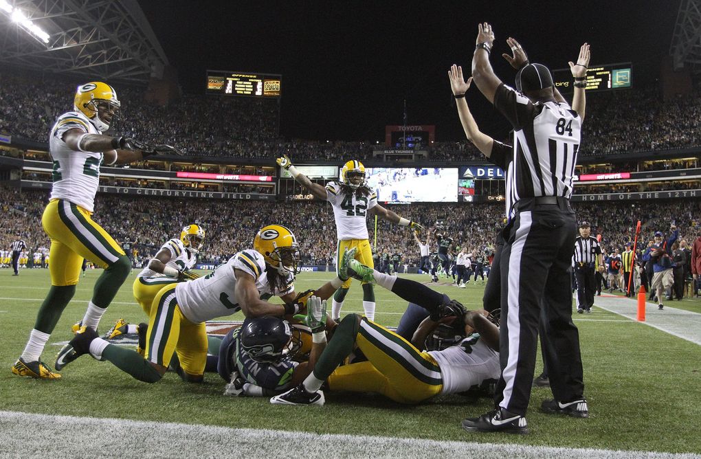 Officials call a touchdown after Seahawks wide receiver Golden Tate pulled in a last-second pass by Russell Wilson to defeat the Green Bay Packers in the “Fail Mary” game Sept. 24, 2012, at CenturyLink Field (John Lok / The Seattle Times)
