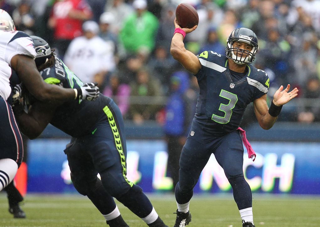 Seahawks quarterback Russell Wilson finds a receiver downfield against the New England Patriots in the second half Oct. 14, 2012, at CenturyLink Field. (John Lok / The Seattle Times)