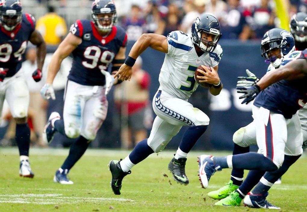 Seahawks quarterback Russell Wilson keeps the football against the Houston Texans in the second half Sept. 29, 2013, in Houston. Seattle won 23-20 in overtime. (John Lok / The Seattle Times)