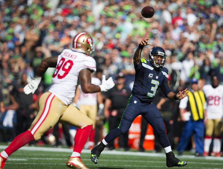 Russell Wilson of the Seattle Seahawks looks to pass against the San