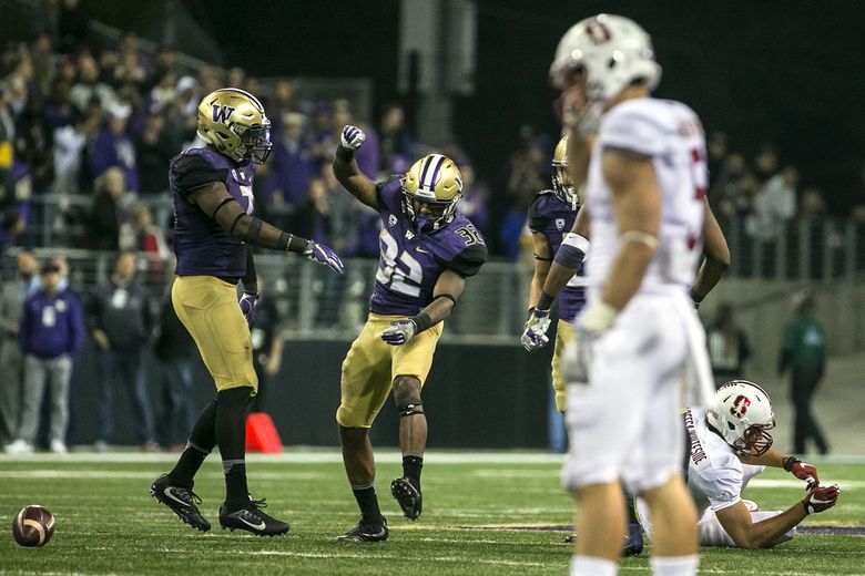 Washington Huskies defensive back Budda Baker (32) celebrates after making a hit on Stanford Cardinal wide receiver JJ Arcega-Whiteside (on ground on right) to force an incompletion in the fourth quarter.  (Johnny Andrews / The Seattle Times)