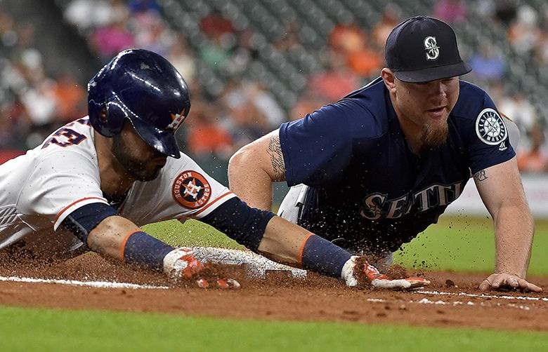 Seattle Mariners first baseman Adam Lind, right, puts out Houston Astros’ Marwin Gonzalez during the fourth inning of a baseball game, Monday, Sept. 26, 2016, in Houston. (AP Photo/Eric Christian Smith) TXES109