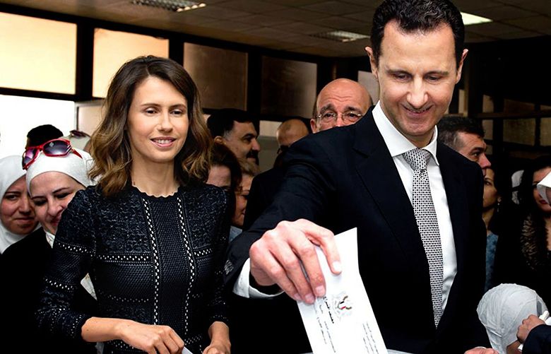 FILE – This April 13, 2016 file photo, released on the official Facebook page of Syrian Presidency, shows Syrian President Bashar Assad casting his ballot in the parliamentary elections, as his wife Asma, left, stands next to him, in Damascus, Syria. Five years of failed efforts to quell the fighting in Syria have persuaded many observers that the war, inconclusive and catastrophic on a historic scale, may be unresolvable. But a closer look at the landscape allows a glimmer of hope that a turning point may have been reached with the truce that took effect Monday, Sept. 12, 2016. (Syrian Presidency via AP, file) SYR104
