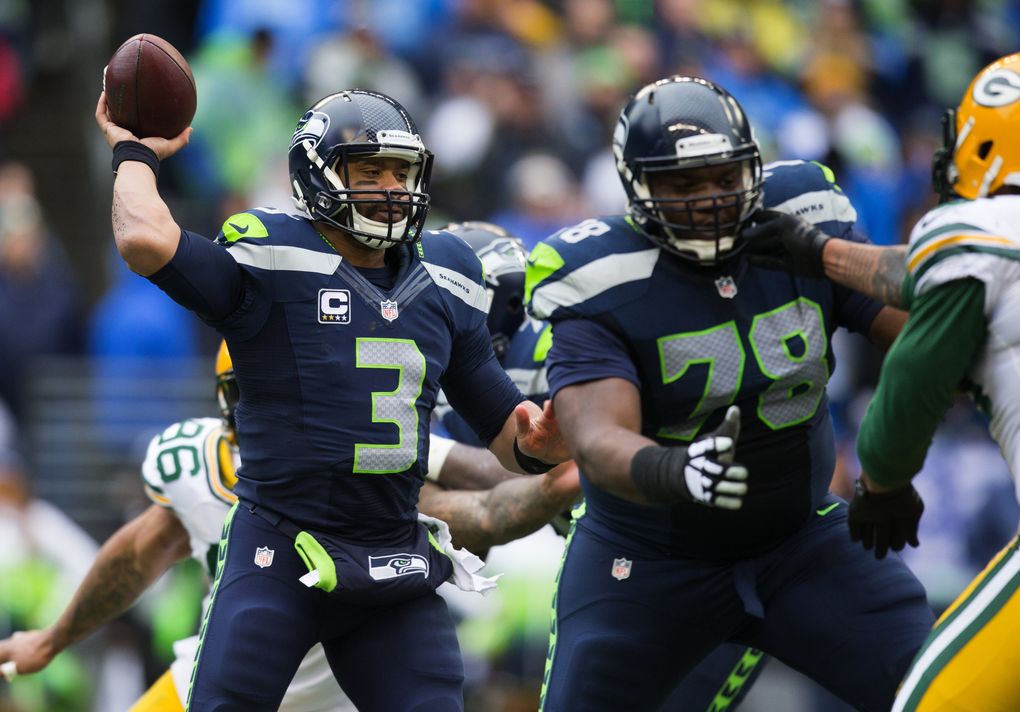 Seahawks quarterback Russell Wilson fires off a short pass to Seahawks running back Robert Turbin for a loss of 2 yards during the second quarter against the Green Bay Packers in the NFC Championship game Jan. 18, 2015, at CenturyLink Field. (Dean Rutz / The Seattle Times)