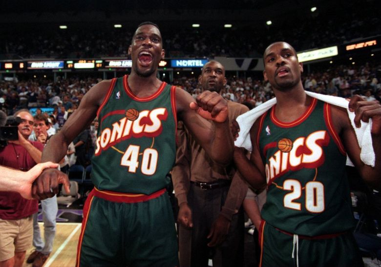 Sonics Shawn Kemp and Gary Payton celebrate the win over the Kings. (5/8/1996) (Rod Mar / THE SEATTLE TIMES)