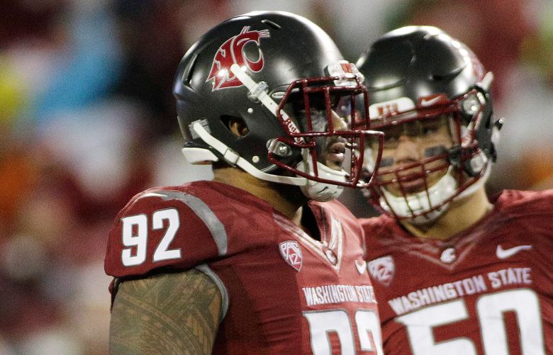 Washington State nose tackle Robert Barber (92) and defensive end Hercules Mata’afa (50) stand on the field during the second half of an NCAA college football game against UCLA in Pullman, Wash., Saturday, Oct. 15, 2016. (AP Photo/Young Kwak)