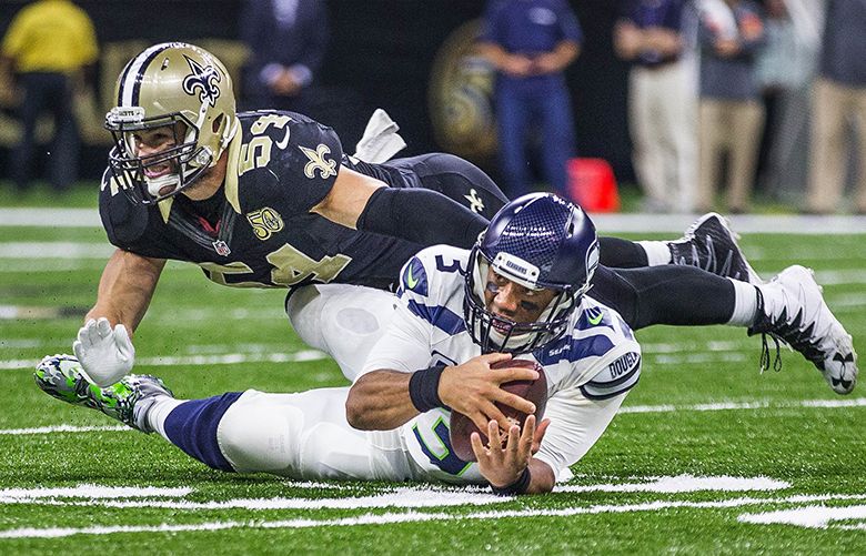 On 3rd and 1 from the 32, Russell Wilson rushes for the first down narrowly avoiding the full hit by Saints linebacker Nate Stupar.   The Seattle Seahawks played the New Orleans Saints Sunday, October 30, 2016 at the Mercedes-Benz Superdome in New Orleans, LA.