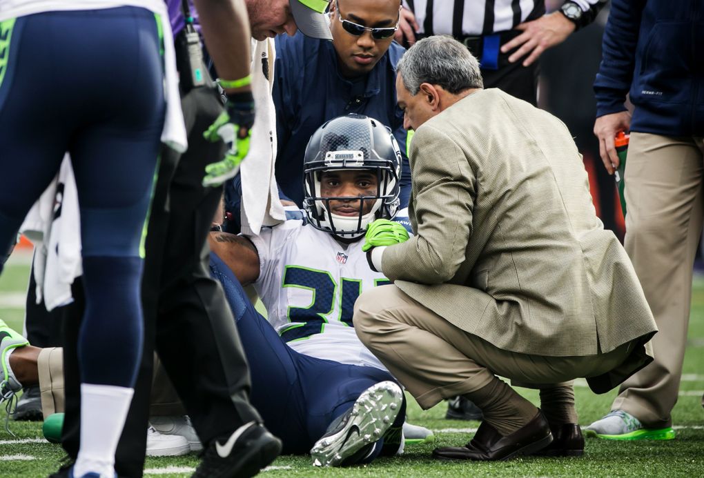 Seahawks running back Thomas Rawls is helped up after injuring his ankle in the first quarter of the Seahawks-Ravens game last December. (Bettina Hansen/The Seattle Times)