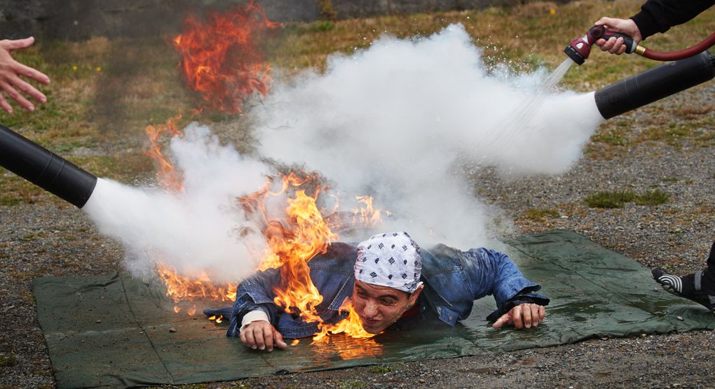 International Stunt School student Cristian Buitrago hits the mat during “fire-burn day” as his clothes are extinguished. Stunt actors coat themselves in a special gel to prevent flesh burns. (Benjamin Benschneider/The Seattle Times)
